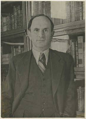 Фотография В.Г. Лидина у книжных полок / Фот. Л. Алпатов.